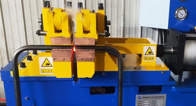 Carbon steel bars are being welded with a butt welding machine.
